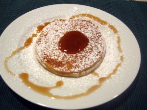 Sunday pancake served with maple syrup and confectioner's sugar