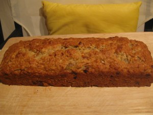 Banana bread made in dark, metallic, long loaf pan